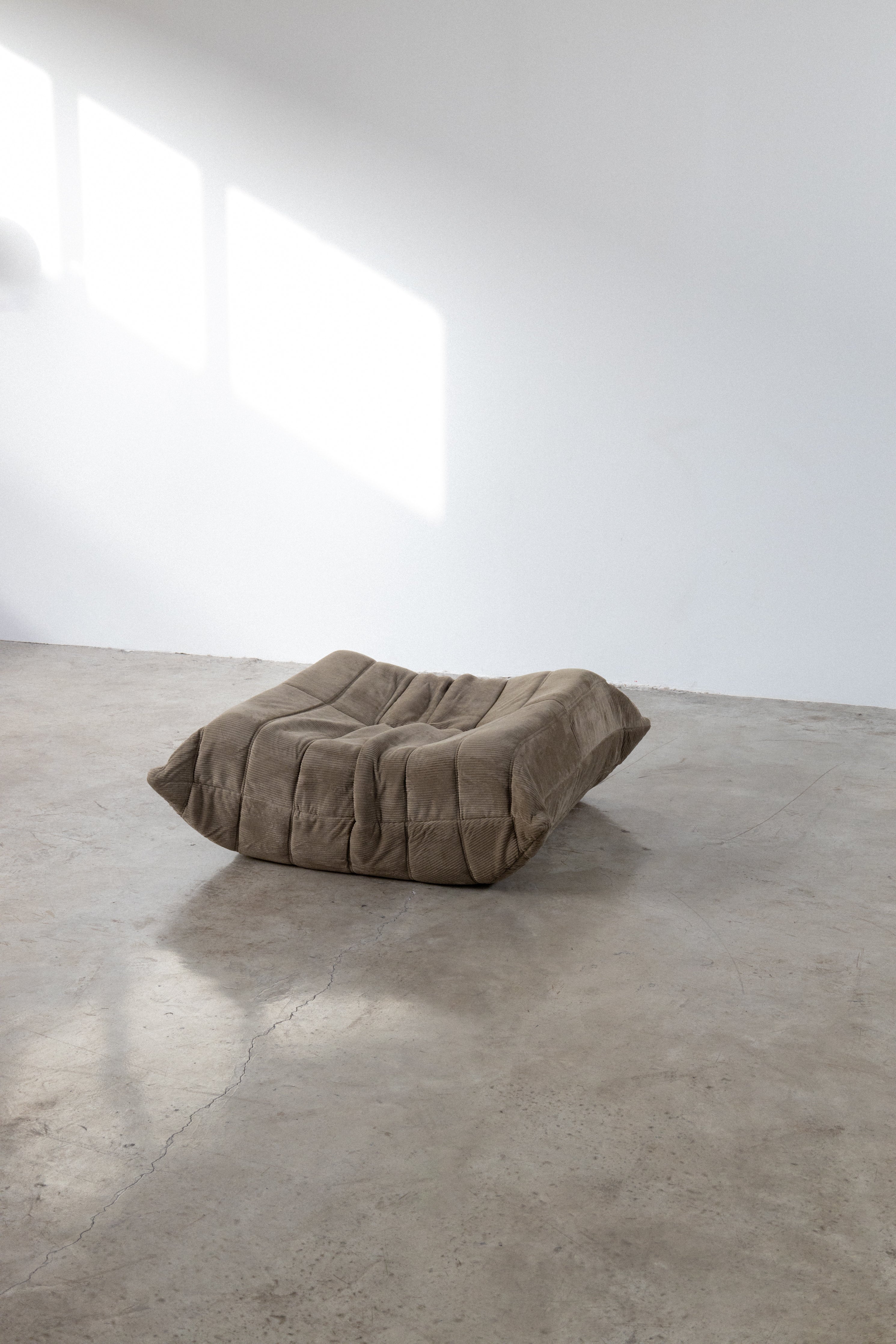 Light brown modular sofa in corduroy fabric, showcasing a one-seater design, set against a minimalist background.