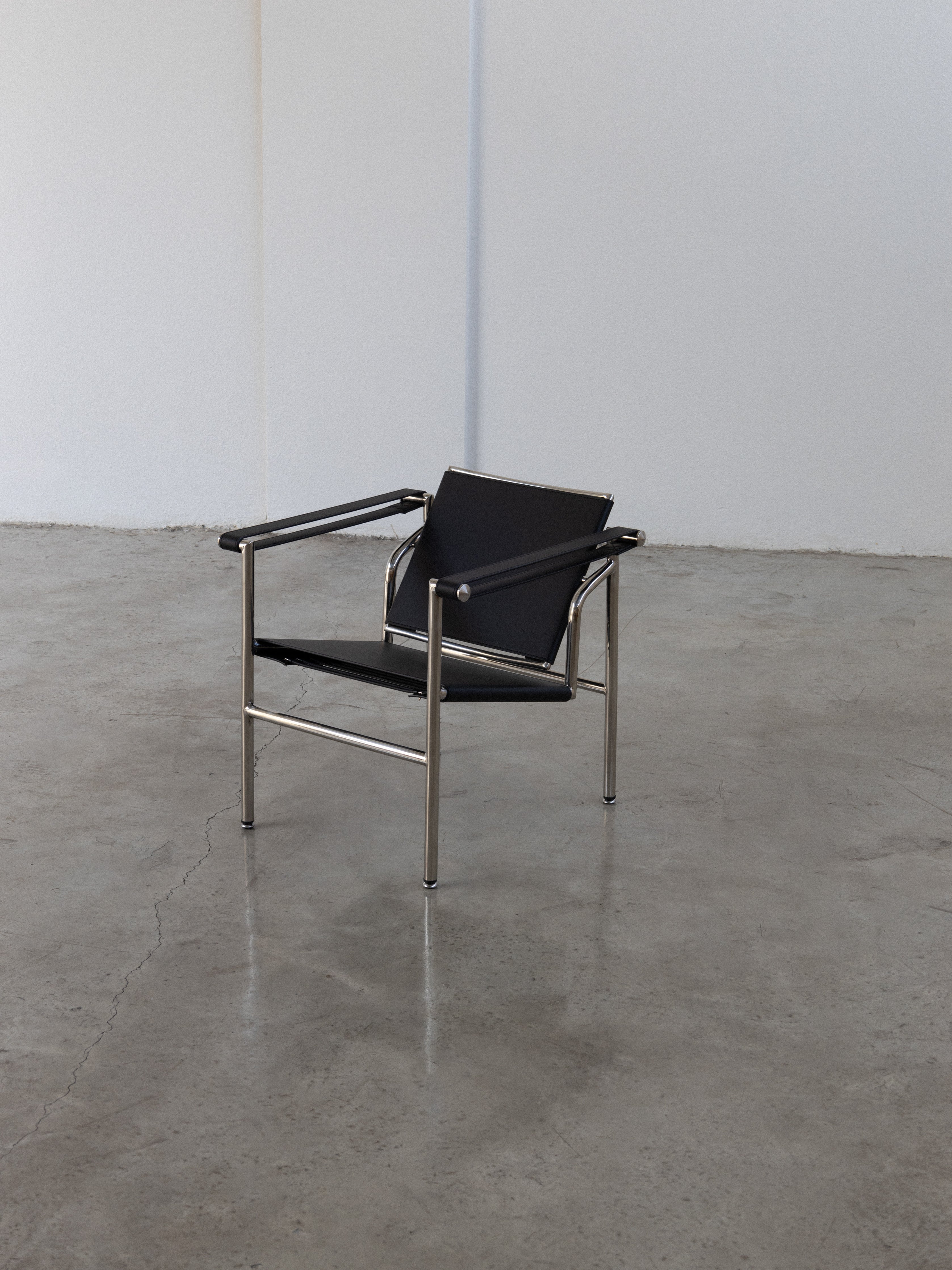 LC1 Basculant Chair in a modern interior setting with a sleek design and minimalist aesthetic.