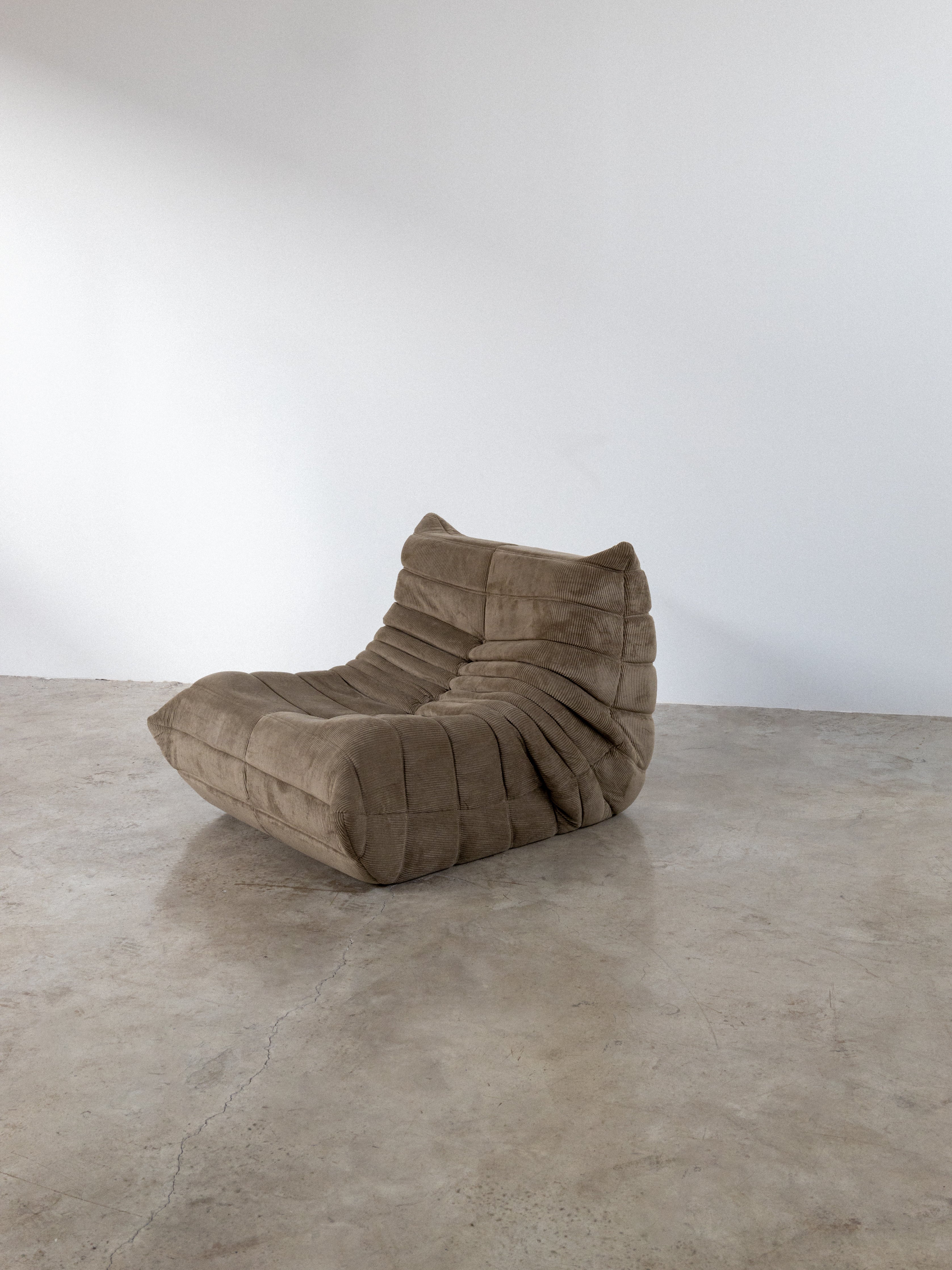 Light brown modular sofa in corduroy design, ideal for modern living spaces, featuring a unique contour for comfort.