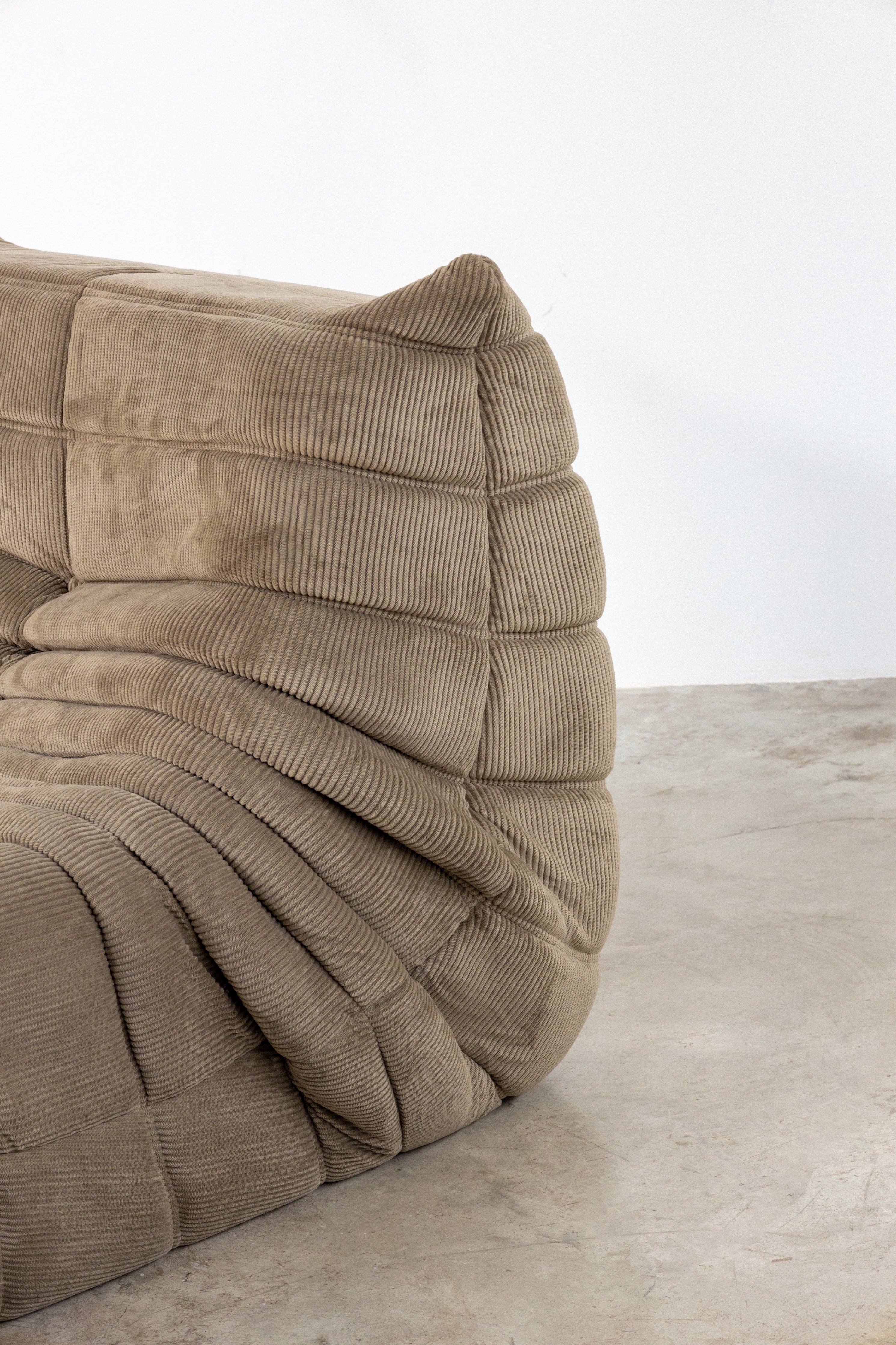 Light brown modular sofa in corduroy, showcasing a unique textured design, perfect for modern living spaces.